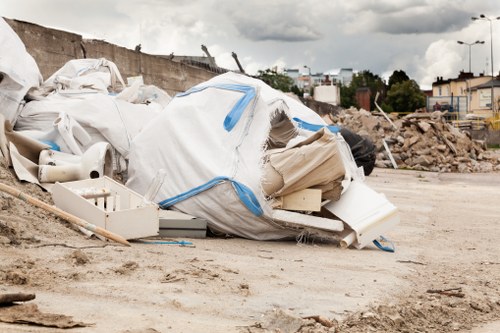 Residential area in Battersea with a skip placed on the sidewalk.