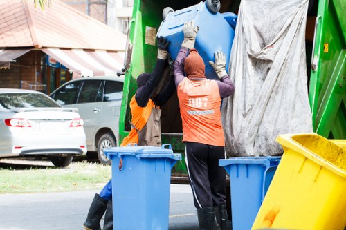 Workers handling construction waste disposal